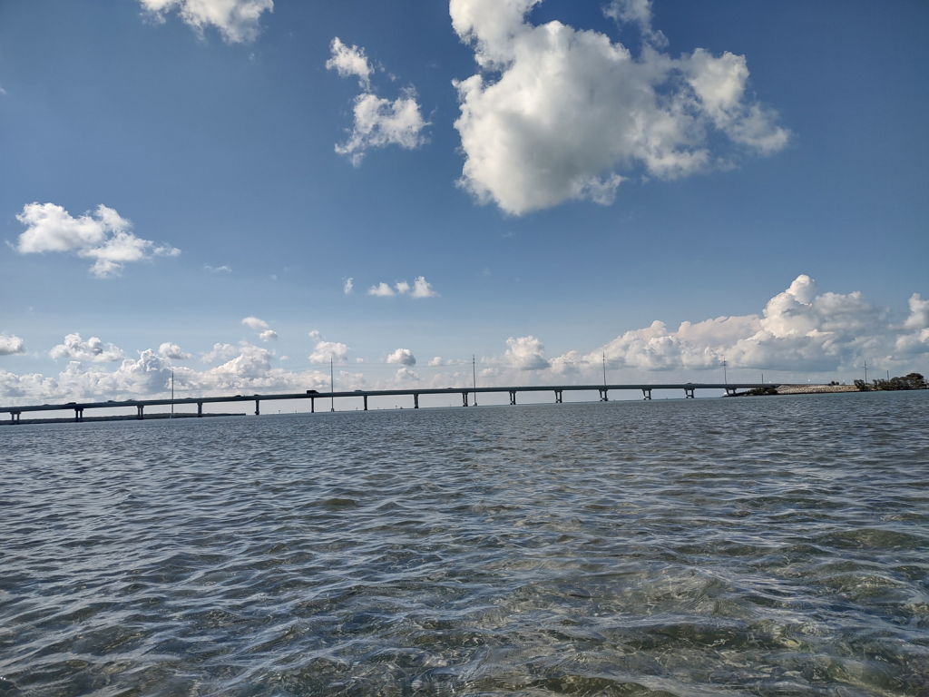 The Overseas Highway as seen from a kayak across crystal clear water 
