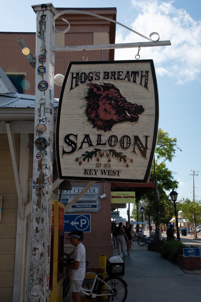 The Hog's Breath Saloon sign hangs above the bar as you look down Duval Street.